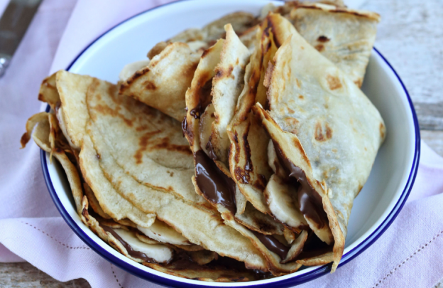 Bowl containing pancakes with Nutella on them